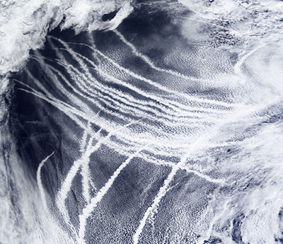 Wood is also interested in ways to make clouds brighter to cool the Earth, including injecting particles into marine clouds. That injection is similar to how the emission of particles by ships into clean air can seed clouds and leave ship tracks like these crisscrossing the Pacific Ocean.
